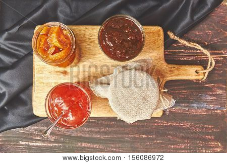 berry and fruit jam on a dark rustic background