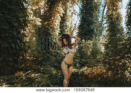 Beauty slim woman in underwear leaf in the forest posing