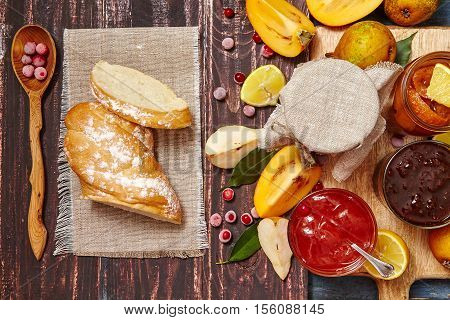ingredients for breakfast - berry and fruit jam fruit toast on a dark rustic background