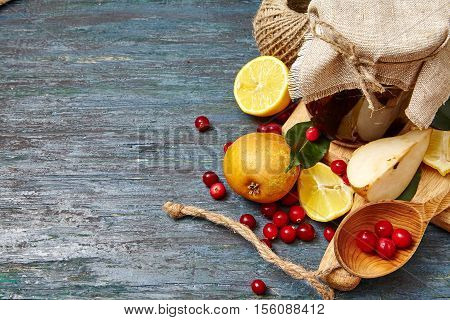 Berry and fruit jam with ingredients on a dark rustic background. Copy space top view.