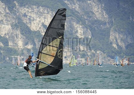 Torbole - Nago, Lago di Garda (Lago Benaco), Italy - August 11, 2015: A windsurfing on Lake Garda in Torbole resort.