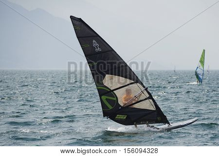 Torbole - Nago, Lago di Garda (Lago Benaco), Italy - August 11, 2015: A windsurfing on Lake Garda in Torbole resort.