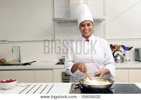 Chef cooking a tasty  risotto  in a modern kitchen