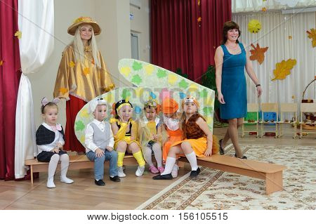 BALASHIKHA RUSSIA - OCTOBER 26: Six small children dressed in carnival costumes and two adult women taking part in autumnal matinee in kindergarten on Zarechnaya Street on October 26 2016 in Balashikha.
