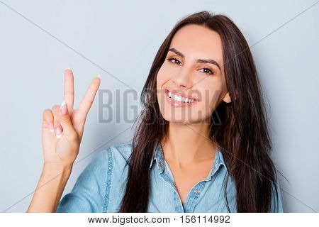 Portrait Of Beautiful Smiling Woman Showing Two Fingers