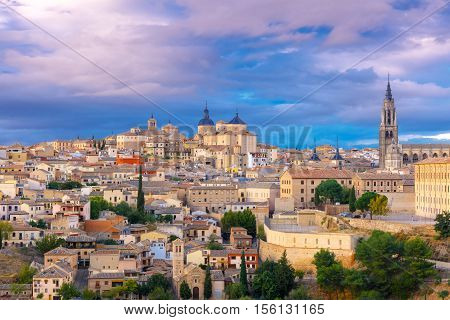 Old city of Toledo with Primate Cathedral of Saint Mary, churches of San Ildelfonso, San Roman and Santo Tome at sunset, Castilla La Mancha, Spain.