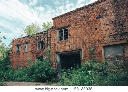 Abandoned Industrial Buildings from red bricks. Ruined car workshop
