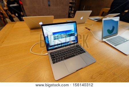 PARIS FRANCE - NOV 10 2016: New latest MacBook Pro Retina with on wooden table. The fourth generation MacBook Pro was revealed on October 27 2016. Phil Schiller described it as the 