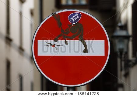 No entry sign with a man that broke a guitar steet art metropolitan