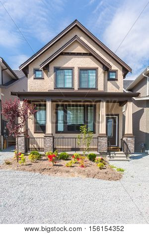 Custom built house in the nice neighbourhood on a sunny day.