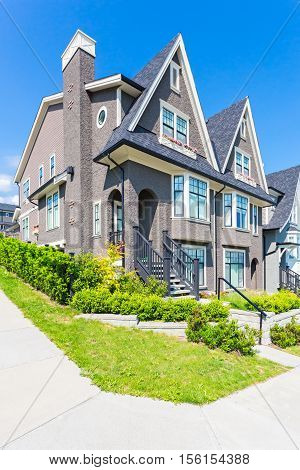 Custom built house in the nice neighbourhood on a sunny day.