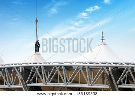 Steel roof construction sites workers at height.