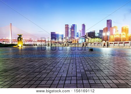 cityscape and skyline of downtown near water of chongqing at night