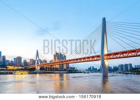 cityscape and skyline of downtown near water of chongqing at night