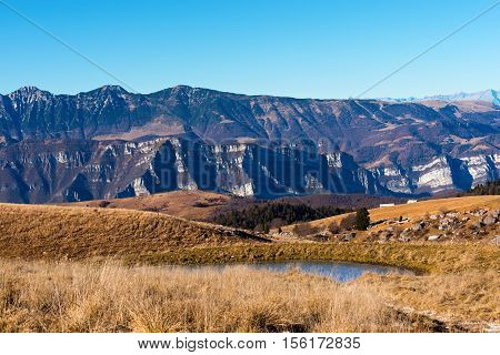 Plateau of Lessinia Regional Natural Park of Lessinia Veneto Verona Italy. In the background the Italian Alps (Monte Baldo - Baldo Mountain)