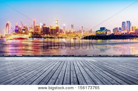 cityscape and skyline of downtown near water of chongqing at night