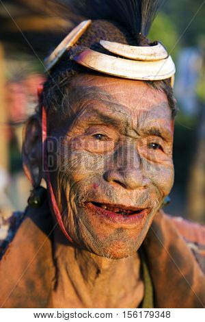 SINGHA CHINGNYU, NAGALAND/INDIA - DECEMBER 8, 2013: Tattooed face of elderly former Singha Chingnyu Village Headhunter. Naga tribes practised headhunting & preserved the heads of enemies as trophies.