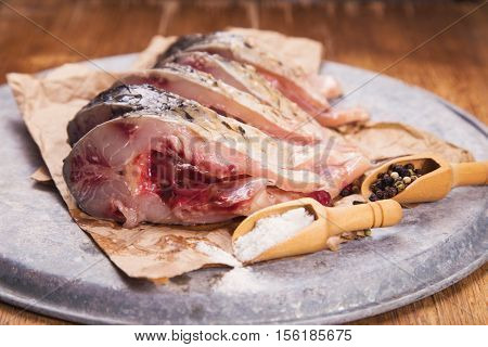 some pieces of fresh raw fish with salt and pepper