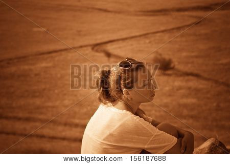 Girl on a hill in the desert. Ordinary people. Effect - Sepia. Nature Monument -Kamyshinskye Mountain Ears. Volgograd region Russia