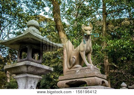 Statue Of Kitsune, Fox, Holding A Key In Its Mouth