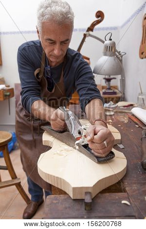 Artisan Lutemaker Working A Violin In His Workshop
