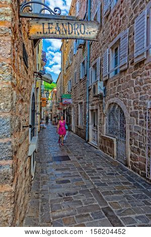 BUDVA, MONTENEGRO - JULY 18: Unknown people walking on picturesque narrow street, on July 18, 2014 in Budva, Montenegro. Budva among the oldest urban settlements of the Adriatic coast, a UNESCO World Heritage Site.