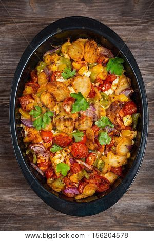 Baked vegetables in pan with herbs