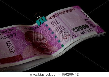 The new rupee 2000 currency notes introduced in india to curb black money. Isolated on black