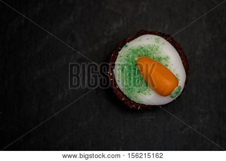 Small Round Carrot Cake On Black Background