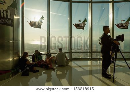 DUBAI UAE - NOVEMBER 8 2016: Tourists on Burj Khalifa tower. This skyscraper is the tallest man-made structure in the world measuring 828 m. Completed in 2009. people at the top the observation deck of the highest building in the world Burj al Khalifa
