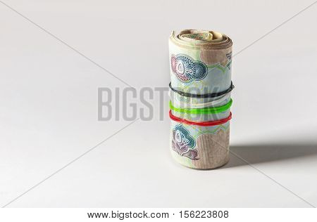UAE national day celebration concept. UAE currency notes tied with national color coded rubber bands.