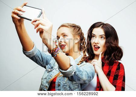 best friends teenage girls together having fun, posing emotional on white background, besties happy smiling, lifestyle people concept close up