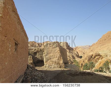 dwellings of berbers in the foot of Atlassky mountains about a green oasis