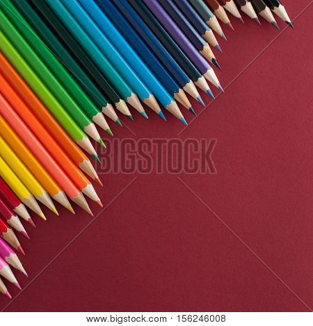 Colour pencils - on red texture background