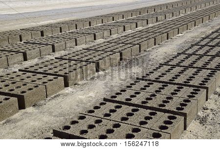 Cinder Blocks Lie On The Ground And Dried. On Cinder Block Production Plant.