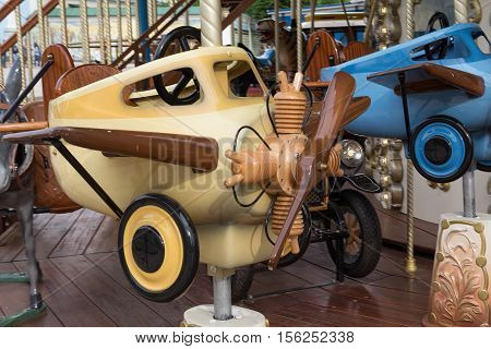 Retro plane on the carousel street. Carnival