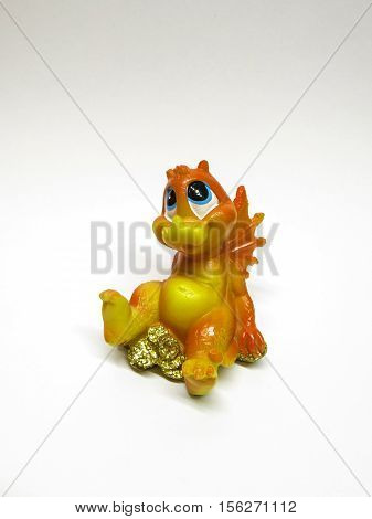 object isolated small statuette of little dragon on a white background