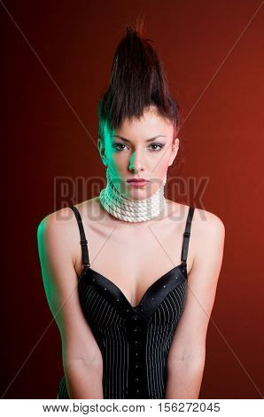 Portrait young woman wearning corset with necklace of rope studio shot