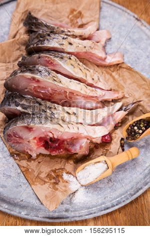 some pieces of fresh raw fish with salt and pepper