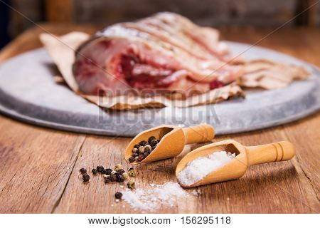 some pieces of fresh raw fish with salt and pepper
