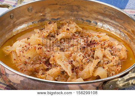 Traditional Turkish food called kapuska in copper pan.