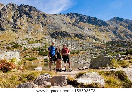 Tourists in beautiful Vysne Kozie pleso - Mlynicka dolina on the way to Bystre sedlo - in slovakian high Tatra mountains. Summer panorama with great weather and blue sky