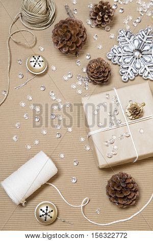 Wrapping Christmas presents on a cardboard background