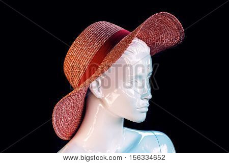 Fashion female mannequin head with hat isolated on black background
