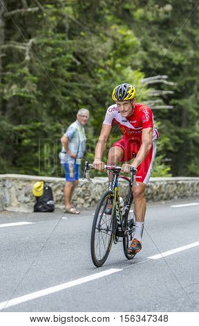 Col du Tourmalet France - July 242014: The French cyclist Adrien Petit of Cofidis Team climbing the difficult road to Col du Tourmalet in Pyrenees Mountains during the stage 18 of Le Tour de France 2014.