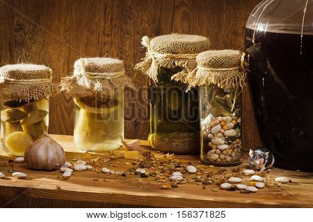 Mouse in larder with stockpiles on old wooden table