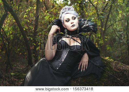 Beautiful woman a witch in the dark forest.