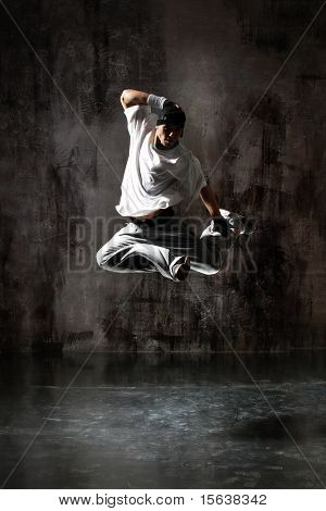 	modern dancer poses in front of the old dirty wall