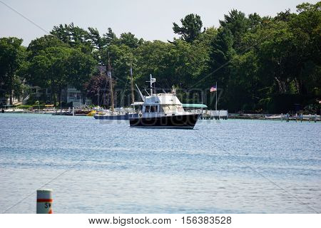 HARBOR POINT, MICHIGAN / UNITED STATES - AUGUST 3, 2016: A boat is anchored off the shore of Harbor Point.