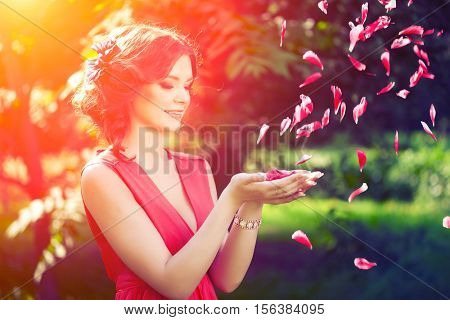 Beautiful girl on the nature in the park. Against the background of the summer lanshaft. Young romantic woman in the sunshine, sunset. Allergic to pollen of flowers. Spring allergy 